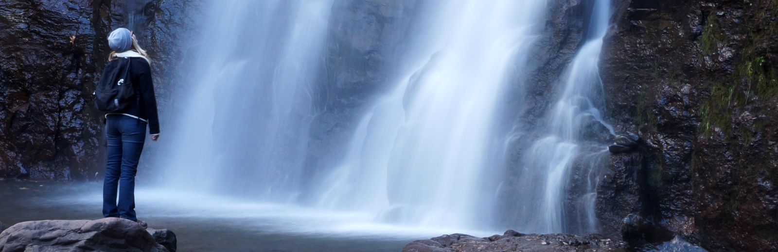 Hiker at falls by Thomas J. Faust