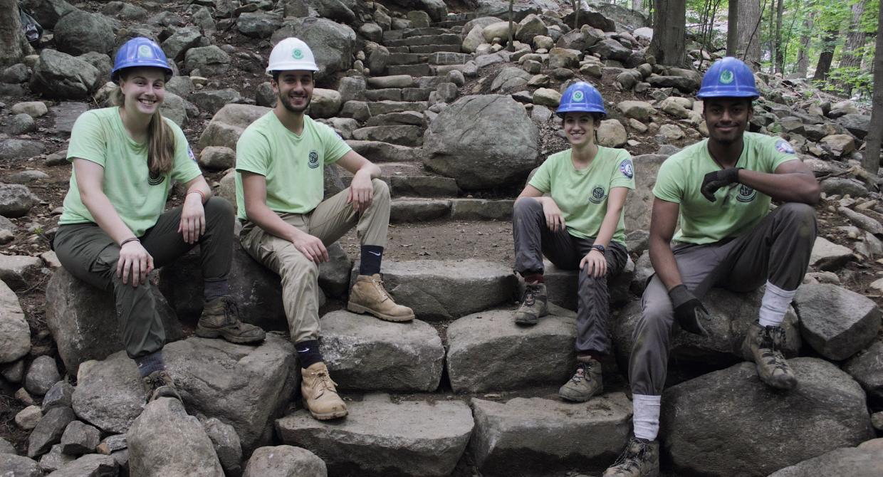 Sweet Water Trail Crew proudly sitting on their stone steps built on the Ramapo Valley County Reservation Vista Loop. Photo by Brayden Donnelly.