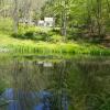 Reflections of house on Journey's End Pond Photo: Jane Daniels