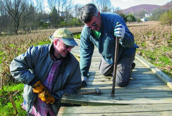 West Jersey Crew Chief David Day and crew member Pete Zuroff work on repairing old decking on the Pochuck Boardwalk. Photo by Georgette Weir.