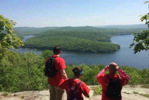 Hikers enjoy a scenic overlook of a lake in Norvin Green State Forest. Photo by Peter Dolan.