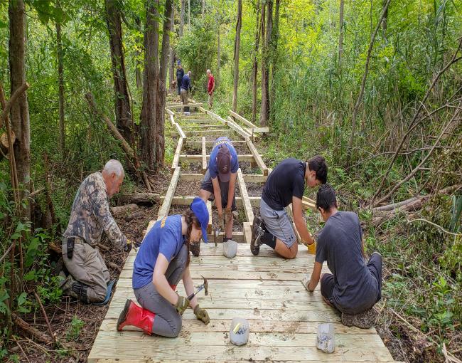 Westchester Trail Crew works on the Mohansic Trailway boardwalk. Photo by Jane Daniels.